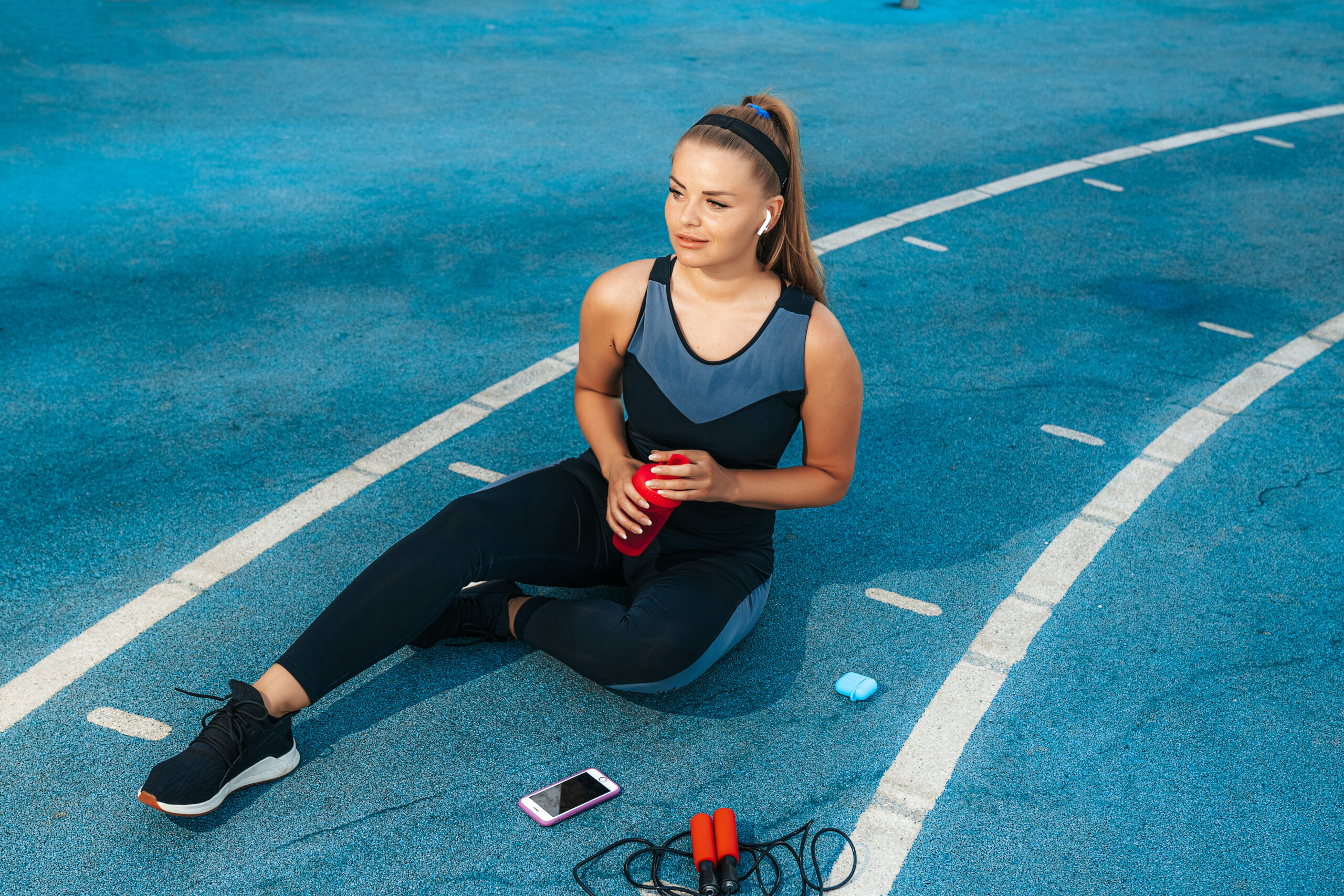 woman sitting playground with bottle water scaled woman sitting playground with bottle water scaled